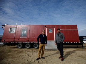 Alta-Fab Structures President Mark Taillefer, left, and CEO Hank Van Weelden  stand in front of one of their mobile kitchens in Nisku, Alberta.