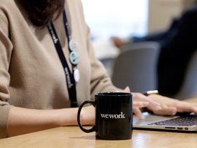 A branded mug sits on a table inside the WeWork Ocean Gate Minatomirai co-working office space, operated by The We Company, in Yokohama, Japan, on Friday, Oct. 11, 2019.