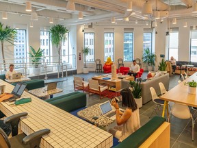 Members work in the cafeteria at the WeWork Cos Inc. Manhattan offices.