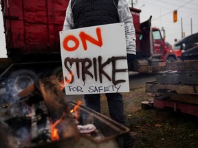 A Teamsters Canada union worker pickets at the Canadian National Railway at the CN Rail Brampton Intermodal Terminal after both parties failed to resolve contract issues, in Brampton, Ontario, Canada November 19, 2019.