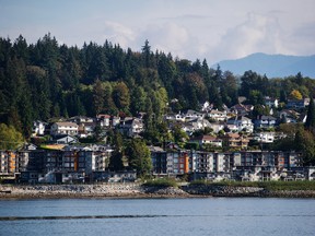 Residential condo buildings and single family houses are seen above Burrard Inlet in North Vancouver, British Columbia