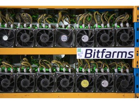 Miners are seen at the Bitfarms bitcoin mine in Magog, Que., on May 8, 2019. Bitfarms marketed itself last spring as a socially conscious company, harnessing unused, sustainable hydroelectricity to help power Quebec's digital economy while also providing much-needed revenue for the province's struggling regions. But since that time, the cryptocurrency mining firm has run into difficulties.