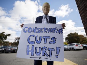 A protestor is seen wearing a mask of Ontario Premier Doug Ford in Toronto.