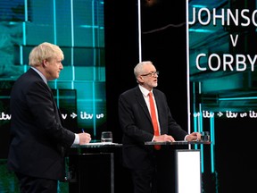 Conservative leader Boris Johnson and Labour leader Jeremy Corbyn are seen during a televised debate ahead of general election in London, Britain, November 19, 2019.