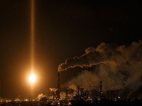 Light from a flare from Imperial Oil's Strathcona Refinery lights up the sky over Edmonton, on Tuesday.