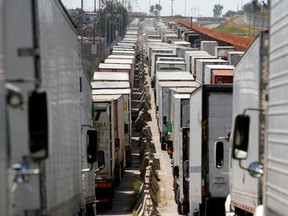 Trucks wait in a long queue for border customs control to cross into the U.S. at the Otay border crossing in Tijuana, Mexico.