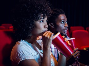 A couple at a movie theatre.