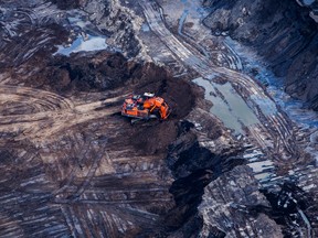 An excavator is seen at the Suncor Energy Inc. Millennium mine in this aerial photograph taken above the Athabasca oilsands near Fort McMurray, Alberta.