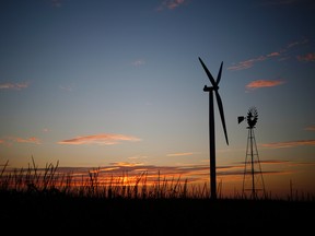 The silhouette of a wind turbine operated by Pattern Energy Group Inc. stands at the Amazon Wind Farm Fowler Ridge, operated by Pattern Energy Group Inc., in Fowler, Indiana, U.S.