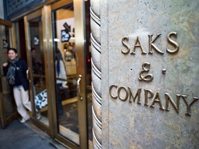 A shopper leaves the Saks Fifth Avenue flagship store. In 2014, an independent appraisal valued the Saks building at $4.8 billion. Tuesday’s report by CBRE Group Inc. put the best-use value at $2.1 billion.