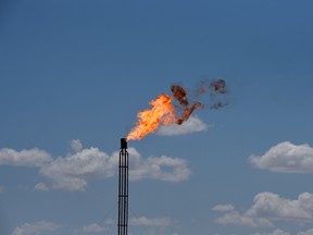 A flare burns off excess gas from a gas plant in the Permian Basin oil production area near Wink, Texas.