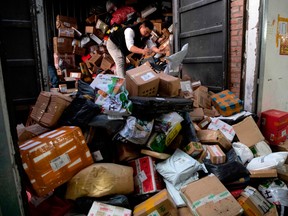 A worker sorts out packages at a delivery company warehouse to be delivered to customers during "Singles' Day" -- the world's biggest 24-hour shopping event -- in Beijing on November 11, 2019.