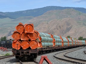 Steel pipe to be used in the oil pipeline construction of Trans Mountain sit on rail cars at a stockpile site in Kamloops, British Columbia.