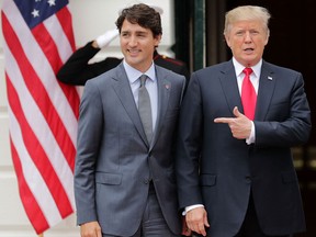 Canadian Prime Minister Justin Trudeau, left, and U.S. President Donald Trump pose for photographs at the White House in October, 2017. Since then Canada has been demoted in Washington, writes Diane Francis.