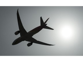 A plane is silhouetted as it takes off from Vancouver International Airport in Richmond, B.C., Monday, May 13, 2019. New polling results suggest many people boarding flights this holiday season don't know about the Liberal government's new regime outlining air passengers' rights.