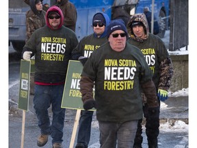 Forestry sector stand outside the legislature in Halifax during a union-sponsored rally on Thursday Dec. 19, 2019. The premier of Nova Scotia is expected to issue a decision today on the fate of an aging pulp mill that supports thousands of jobs across the province.