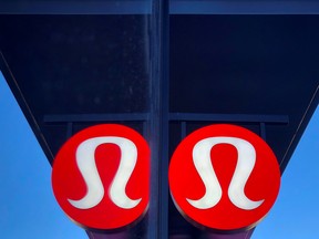 A sign for a Lululemon retail shop is reflected in the store's window at a shopping mall in San Diego, California.