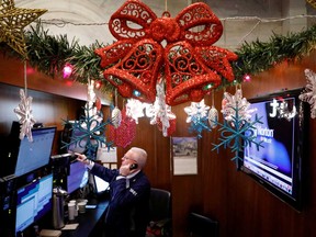 A trader works at his stall on the floor at the New York Stock Exchange in New York.
