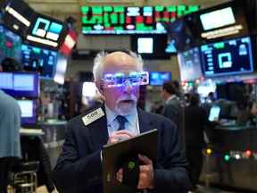 A trader wears 2020 glasses to celebrate the New Year at the New York Stock Exchange.