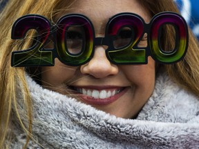 A woman wears glasses as she waits to celebrate New Years Eve in Times Square on December 31, 2019 in New York City.