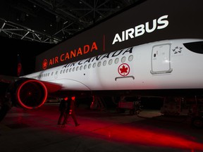Pilots walk to board an Air Canada Airbus SE A220-300 aircraft during an unveiling event in Montreal, Quebec, Canada, on Wednesday, Jan. 15, 2020.
