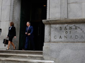 Stephen Poloz, governor of the Bank of Canada, right, and Carolyn Wilkins, senior deputy governor at the Bank of Canada, leave the Bank of Canada building on their way to a press conference at the National Press Theatre in Ottawa, in April 2019.