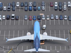 A grounded Boeing 737 MAX airplane is stored on an employee parking lot adjacent to Boeing Field, in Seattle, Washington. After a pair of crashes, the 737 MAX has been grounded by the FAA and other aviation agencies since March, 13, 2019.