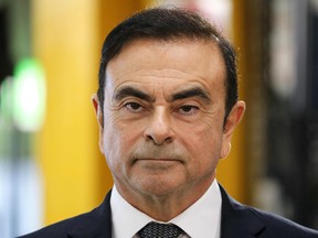 In this file photo taken on November 8, 2018 then Chairman and CEO of Renault-Nissan-Mitsubishi Carlos Ghosn looks on during a visit of French President at the Renault factory, in Maubeuge, northern France.