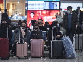 Travelers wear protective masks while waiting for transport at Hongqiao high-speed railway station before Chinese New Year in Shanghai, China, on Wednesday, Jan. 22, 2020.