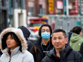 A man wears a mask in downtown Toronto on January 28, 2020.