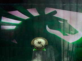 The Aegis of Champions trophy is displayed on the stage in front of the team Liquid logo on Day 3 of The International 2018 Dota 2 Championships at Rogers Arena in Vancouver.