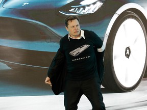 Elon Musk dancing on stage at Tesla's factory outside Shanghai to celebrate delivering the first Model 3 sedans to public customers in China.