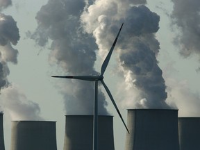 A wind turbine outside a coal-fired power plant in Germany. A recent report concludes Germany’s two-decade orchestrated green energy revolution has been a disastrous failure.