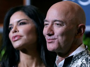 Jeff Bezos, founder of Amazon, and his girlfriend TV presenter Lauren Sanchez pose after arriving at a company event in Mumbai, India, January 16, 2020.