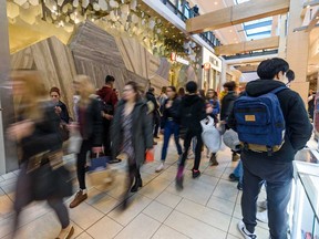 People wait in line to enter Lululemon in Chinook Mall in Calgary for Boxing Day.