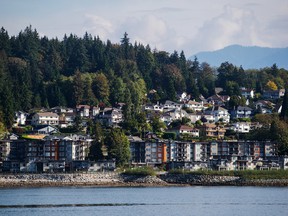 Residential condo buildings and single family houses are seen above Burrard Inlet in North Vancouver, British Columbia.