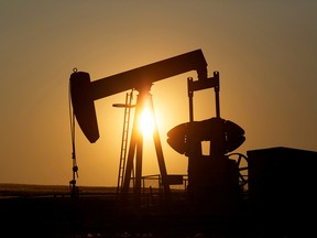 An oil pump jack pumps oil in a field near Calgary.