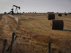A pumpjack works at a well head on an oil and gas installation near Cremona, Alta., Saturday, Oct. 29, 2016.