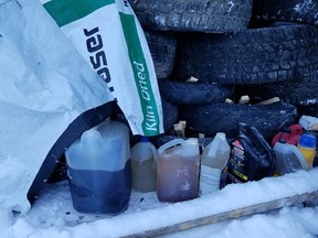 Jugs of accelerants and kindling under a stack of tires in a photo from the RCMP.