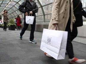 People with shopping bags in Toronto. In an end-of-year survey for Bloomberg News by Nanos Research Group, 55 per cent of Canadians said there's at least a "somewhat likely" chance of a recession this year.