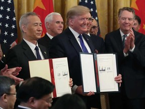 U.S. President Donald Trump and Chinese Vice Premier Liu He, hold up signed agreements of phase 1 of a trade deal between the U.S. and China, in the East Room at the White House, on Jan. 15 in Washington, DC.