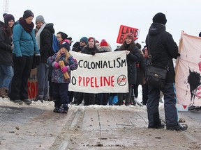 Demonstrators against the Coastal GasLink pipeline that crosses the Wetsuweten territory in British Columbia show their support by blocking the CN tracks in Kingston, Ont., on Sunday, February 9, 2020.