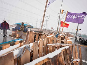 In this file photo taken on February 26, 2020, First Nations protestors man a barricade on Highway 6 near Caledonia, Ontario which the protestors set up in support of the Wet'suwet'en hereditary chiefs and the Tyendinaga Mohawks.