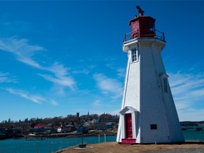 The Mulholland Point Light stands with Lubec, Maine across the water on Campobello Island, Canada.