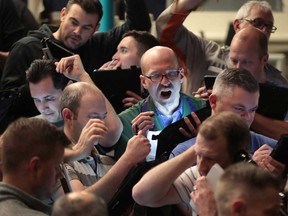 Traders in the S&P options pit on the Cboe Global Markets trading floor in Chicago. Global markets have shed trillions this past week over fears about the spread of the coronavirus.