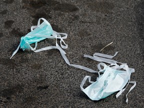Discarded protective face masks on a street outside a hospital in Italy.