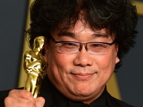 "Parasite" director Bong Joon-ho pose in the press room with his Oscars during the 92nd Oscars at the Dolby Theater in Hollywood, California.
