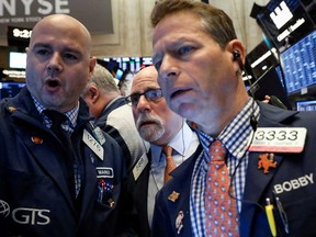 Traders work on the floor at the New York Stock Exchange Friday.