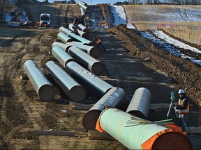 The Trans Mountain Expansion Project pipe going in the ground west of Edmonton.