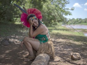 An Indigenous woman from the Pataxo Ha-ha-hae community cries while looking at the Paraopeba river covered in mud, on the sixth day after the collapse of a dam at an iron-ore mine belonging to Brazil's giant mining company Vale near the town of Brumadinho, state of Minas Gerais, southeastern Brazil, on January 30, 2019.